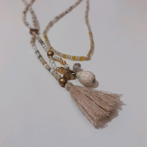 Long beaded necklace new in white and gold shades with tassel