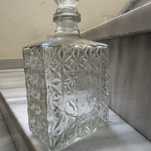 Glass liquor bottle used with embossed design