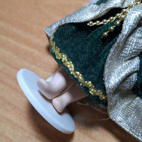 Porcelain doll on stand like new