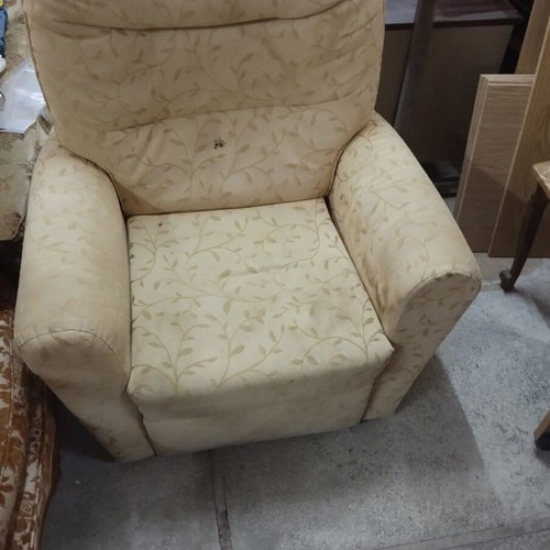 Armchair with footrest and recliner mechanism used, beige with floral pattern