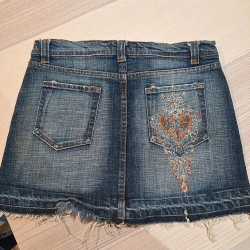 Denim skirt with rhinestone design on back