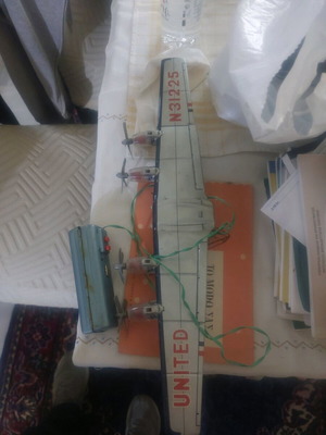 Tin airplane wings used with control, missing wheel