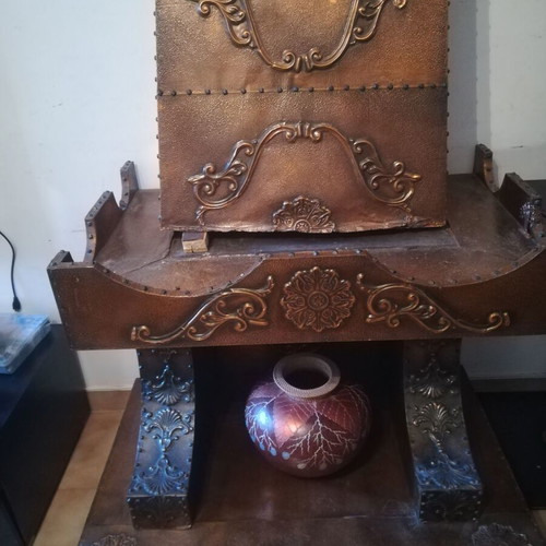 Decorative fireplace set with table and copper wall plaque