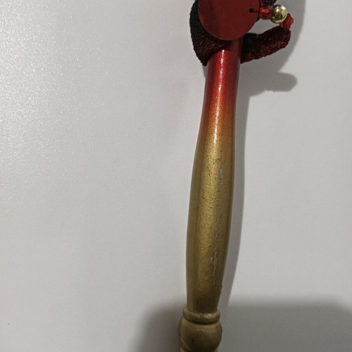 Mask with handle used, burgundy shades with minor wear