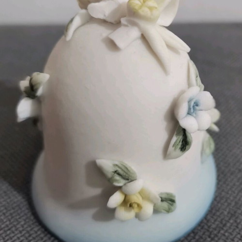 Ceramic bell used with embossed flower designs