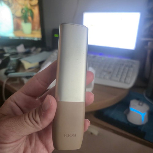 Iqos ILUMA One Gold device used with box and cable