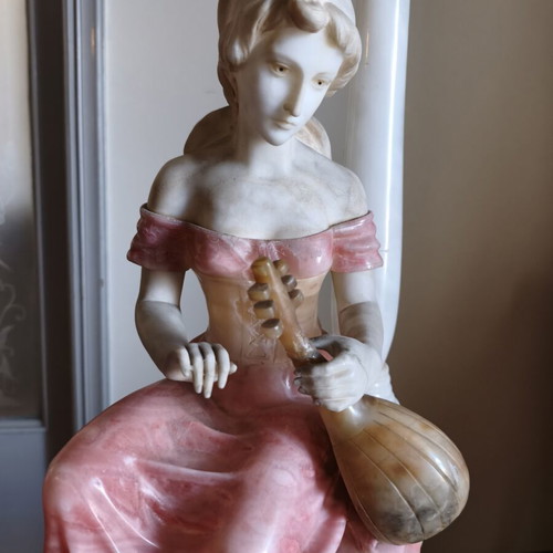 Statue of a woman playing a lute