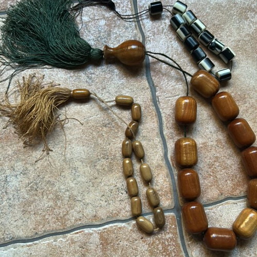 Decorative komboloi set like new, two wooden brown and one black and white