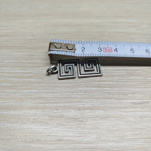 Pendant with double Meander like new, silver color