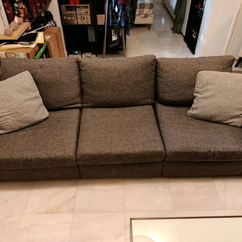 Three-seater sofa used in gray color with two cushions