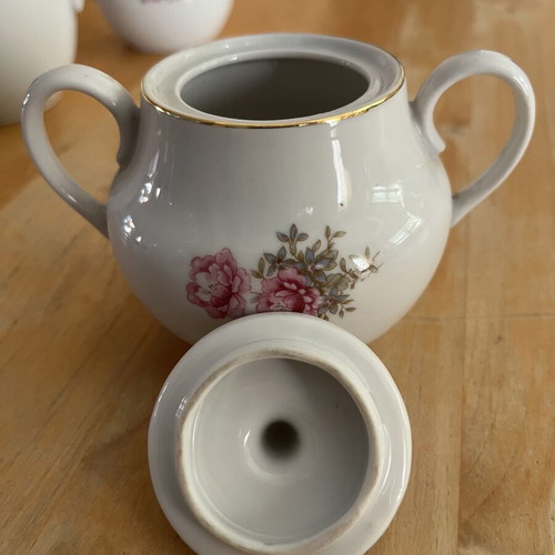 Porcelain tea set used with floral pattern, teapot, creamer, sugar bowl