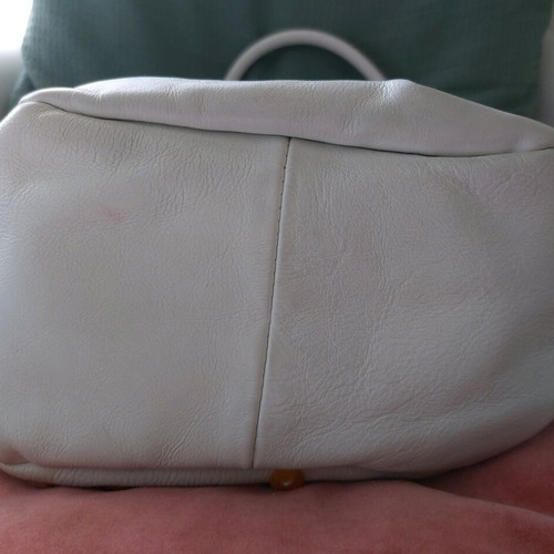 White bucket handbag used with decorative buttons