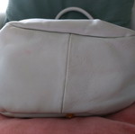 White bucket handbag used with decorative buttons