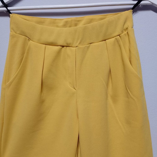 Yellow fabric pants used with elastic waist and pockets
