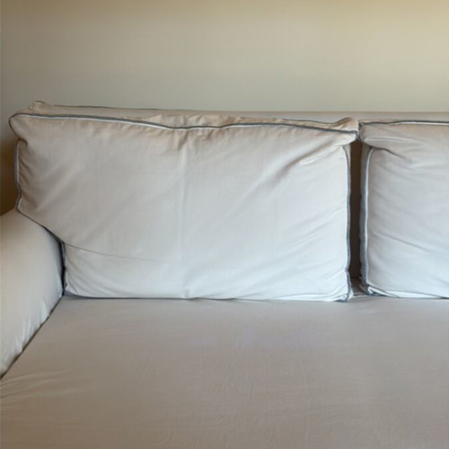 Two-seater sofa like new with ivory cover and grey-blue stitching