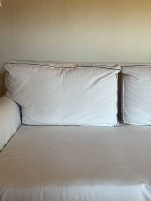 Two-seater sofa like new with ivory cover and grey-blue stitching