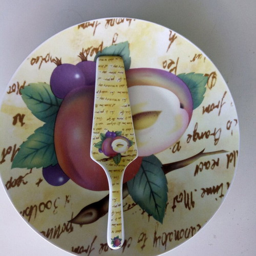 Ceramic serving platter with matching spatula, fruit design