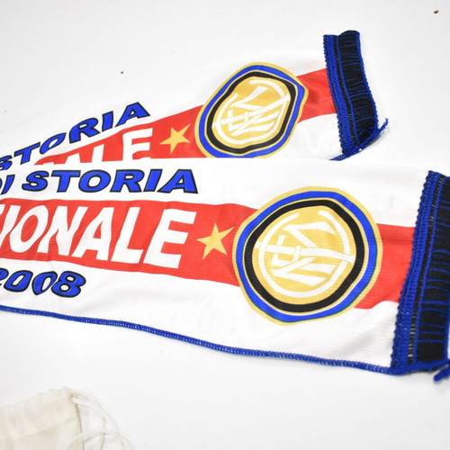 Inter collection with scarves, pennants, cufflinks, magazines and backpack