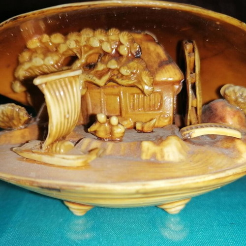 Vintage carved shell with dragon and scenic details