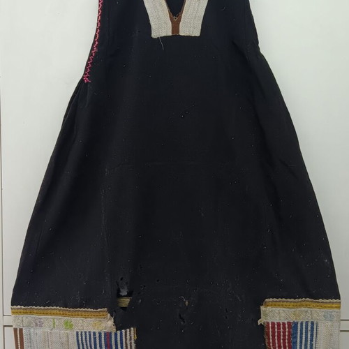 Traditional collectible wool dress used with wear due to age