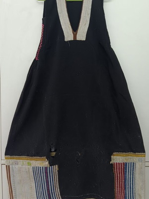 Traditional collectible wool dress used with wear due to age