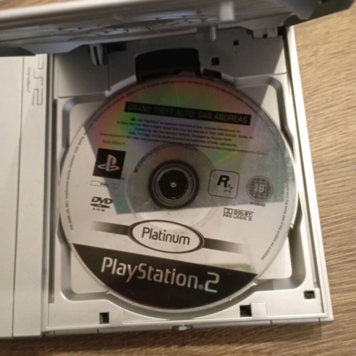 PlayStation 2 console with 3 and 4 games, used