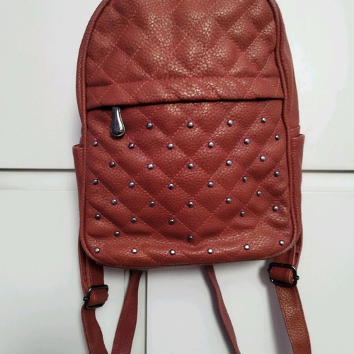 Backpack used red bag with quilted front zipper