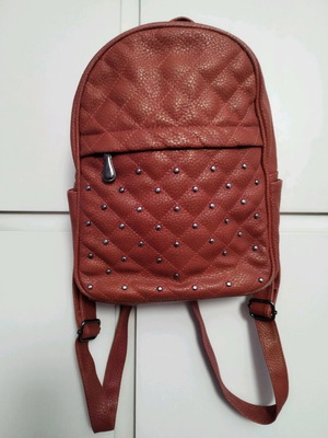Backpack used red bag with quilted front zipper