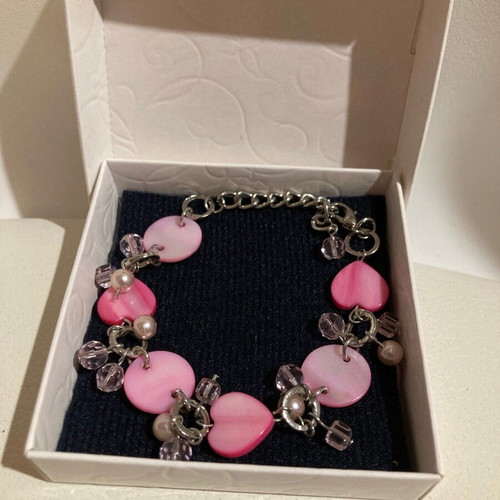 Silver bracelet with pink hearts in a box