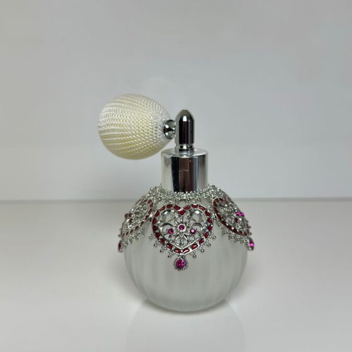 Vintage perfume bottle with pump, decorative hearts and crystals
