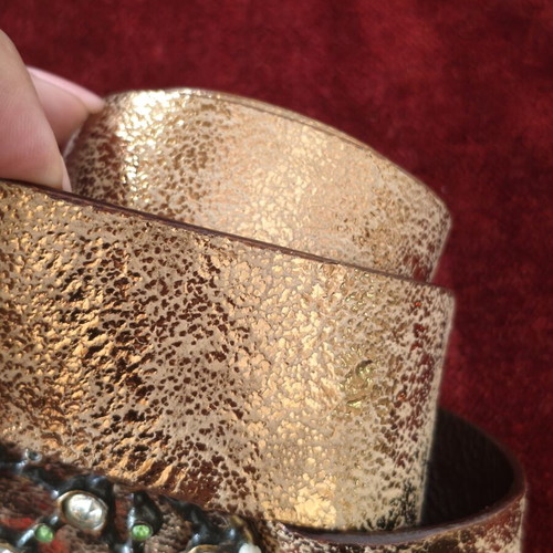 Wide gold belt used with decorative buckle and rhinestones
