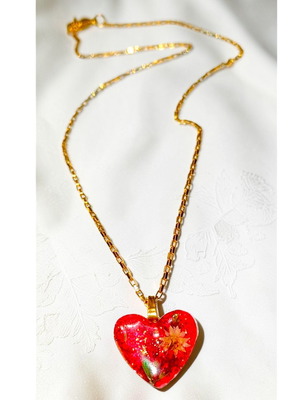 Handmade heart necklace with natural flowers and glitter in resin