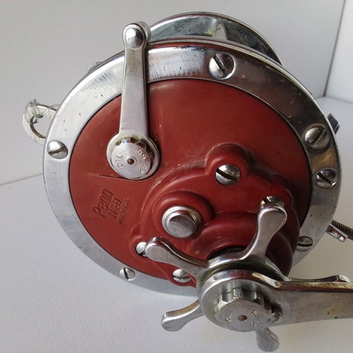 Penn Senator 114H fishing reel with large set of unused artificial lures and soft baits