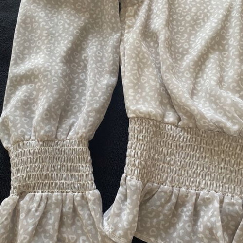 Romantic women's blouse beige used, size M with smocked waist and peplum hem