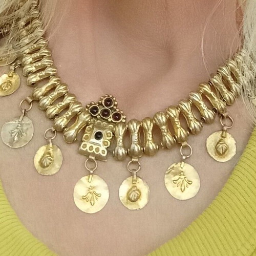 Traditional necklace with vintage symbols used, yellow light color, copper