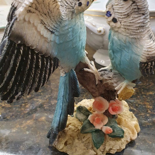 Figurine of two beautiful parrots on a branch like new