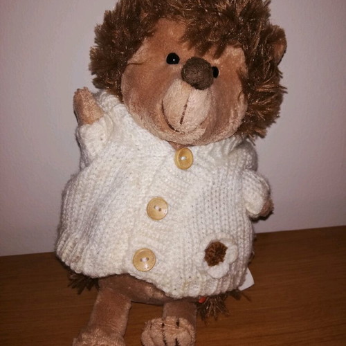 Plush hedgehog used with white knitted jacket