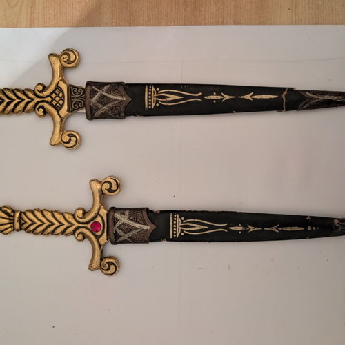 Decorative Spanish stiletto knives with gold handles and black sheaths