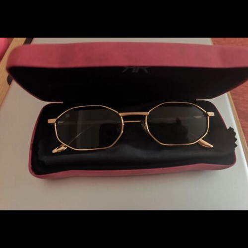 Red Raven sunglasses with gold frame, black lenses
