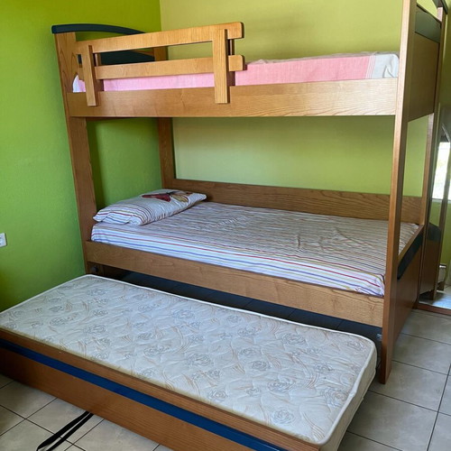 Wooden bunk bed with third sliding bed and mattresses like new