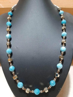 Necklace with dark blue larimar and gold hematite on steel
