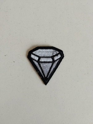 Sewn patch in silver diamond shape like new
