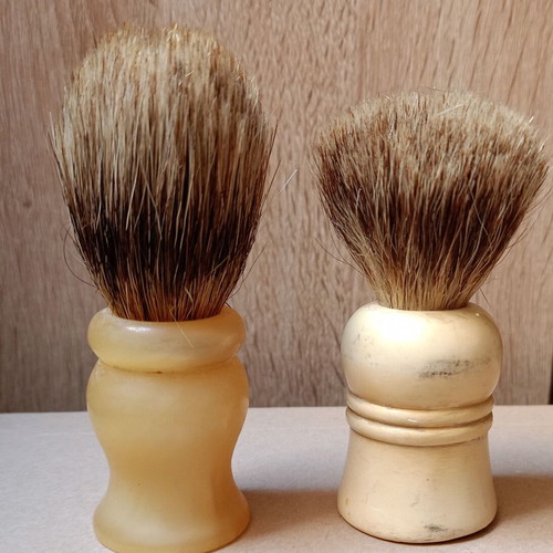 Two shaving brushes, one says it is made in West Germany.