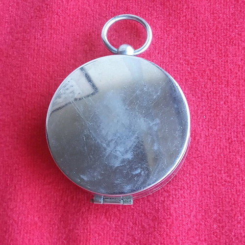 Vintage pocket compass used with metal casing