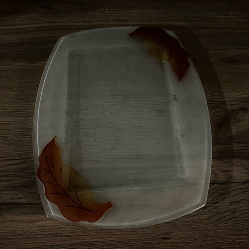 Decorative glass tray used with embossed leaf design