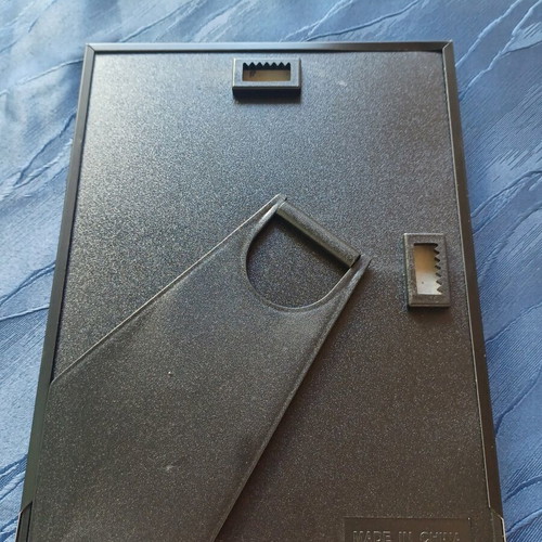 Black photo frame with golden decorative bows used