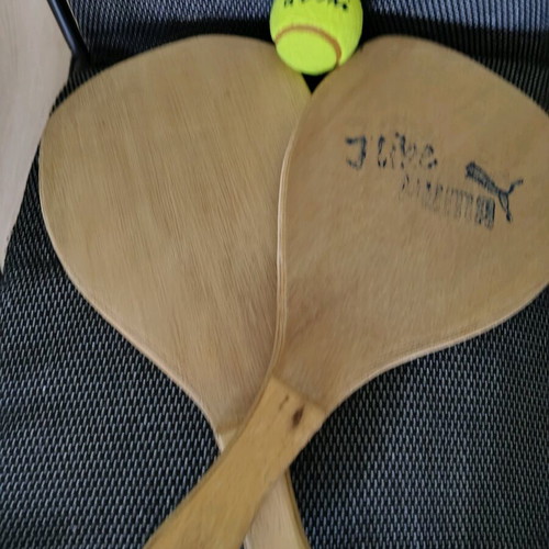Wooden beach rackets used with new ball