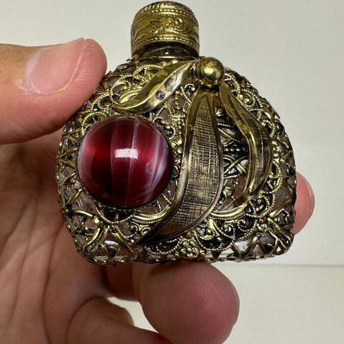 Vintage perfume flacon with filigree metalwork and red cabochon