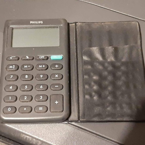 Philips pocket calculator used with vintage card holder