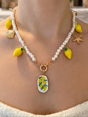 Necklace with faux pearls and charms, like new, white and yellow